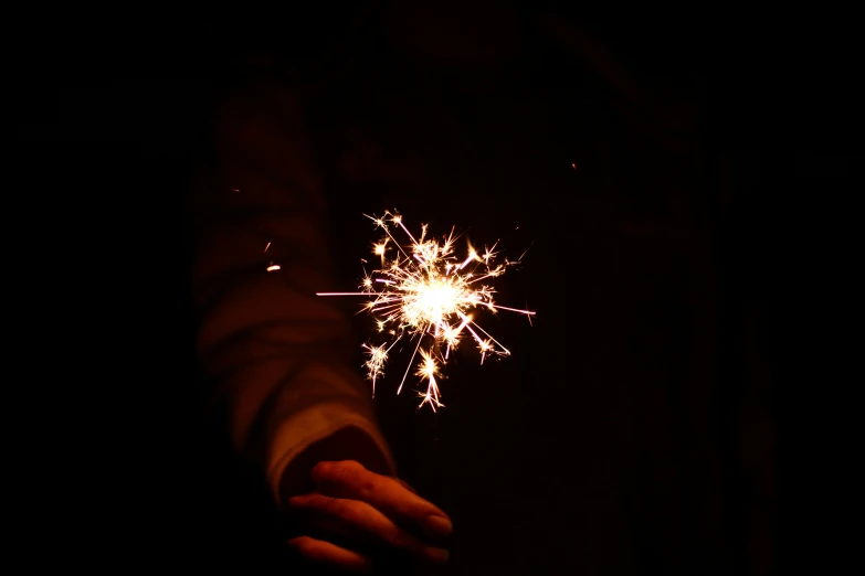 fireworks exploding in the dark of a night with its light on