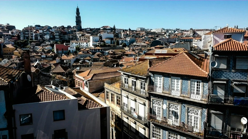 a view over a city from above with roofs and windows