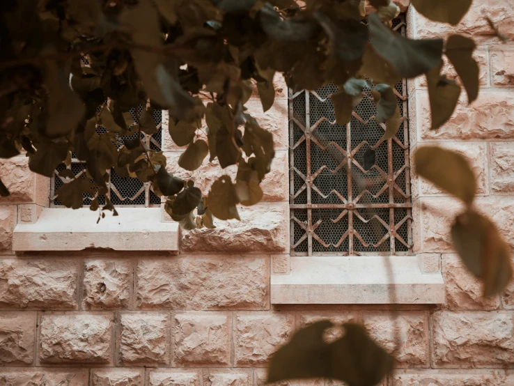 an old stone wall with a grate in the window