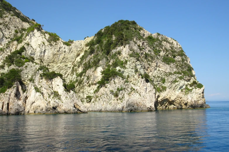 an island with white walls in the ocean