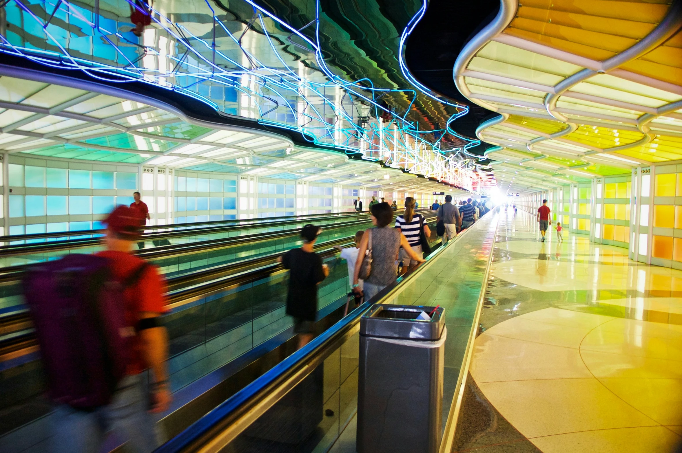 people are at a train station waiting for their luggage