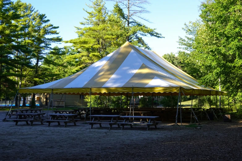 a big tent set up for an event in the woods