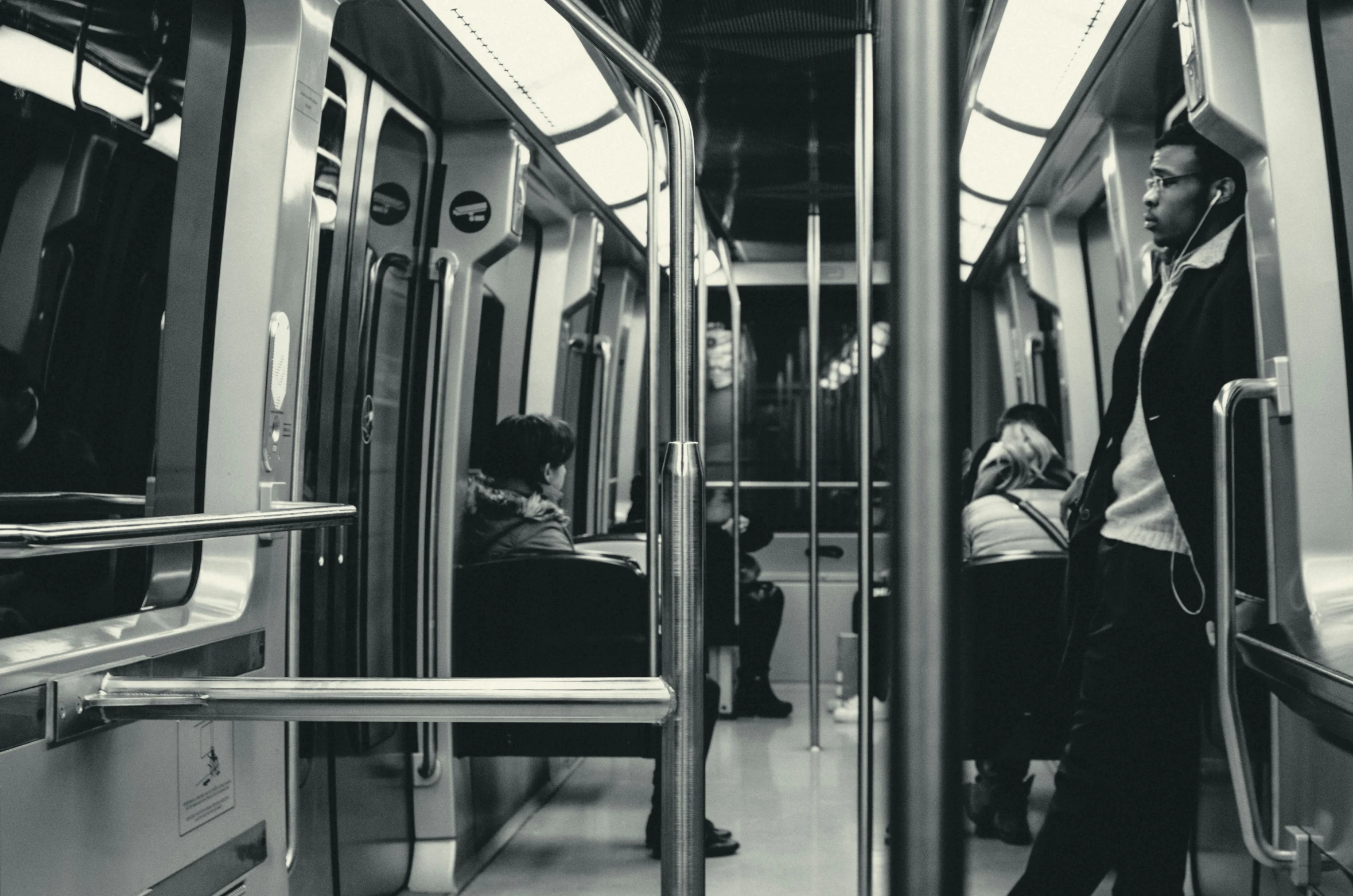 people are riding a subway train with their suitcases