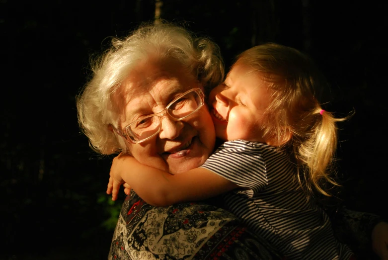 two older women emcing each other at night