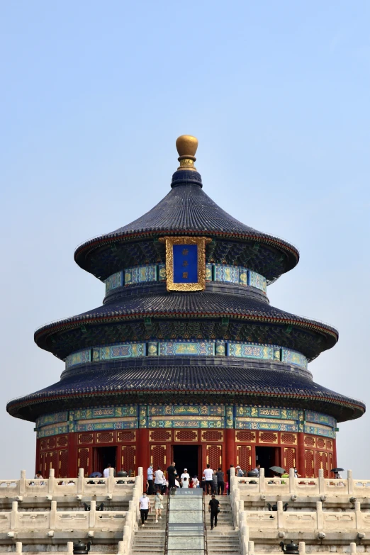 a po looking up at an ornate building that is in front of people