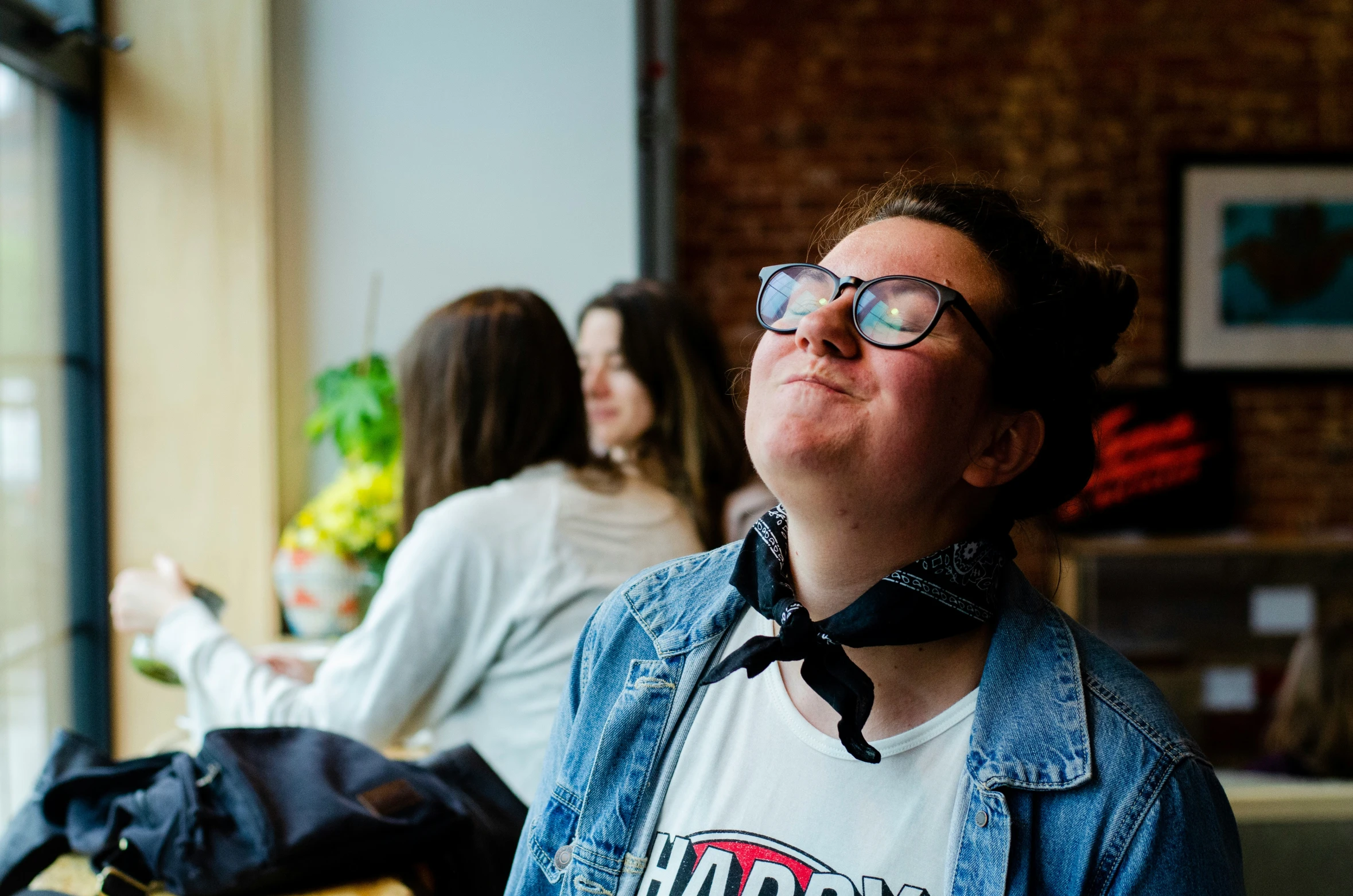 a woman is looking up at soing behind her