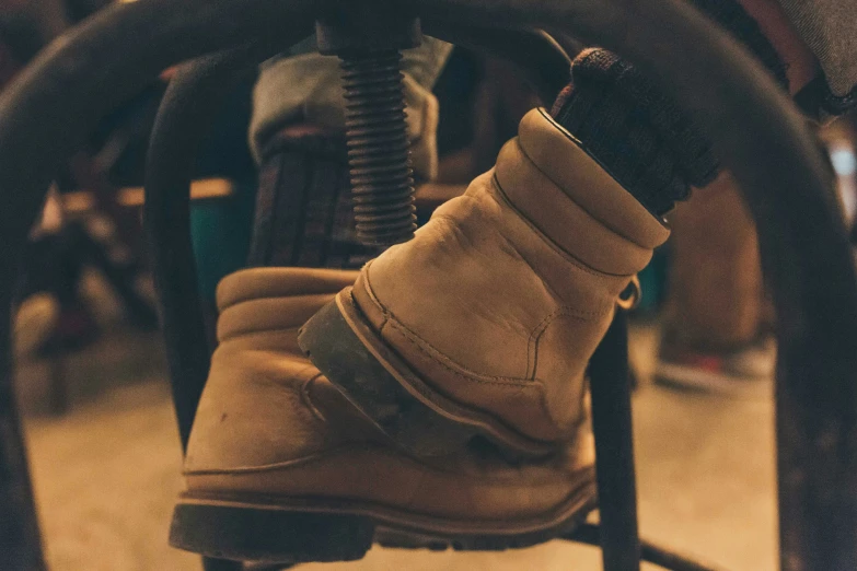 a pair of boot and a black metal chair