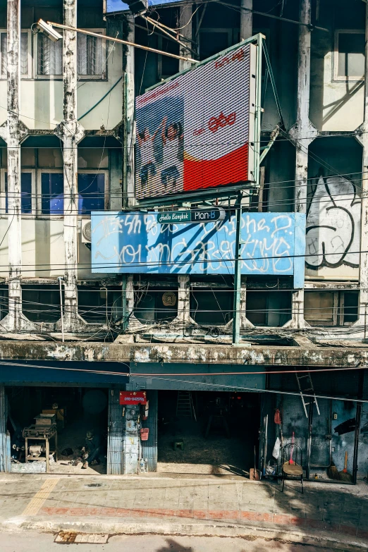 an old building with a fence and street sign