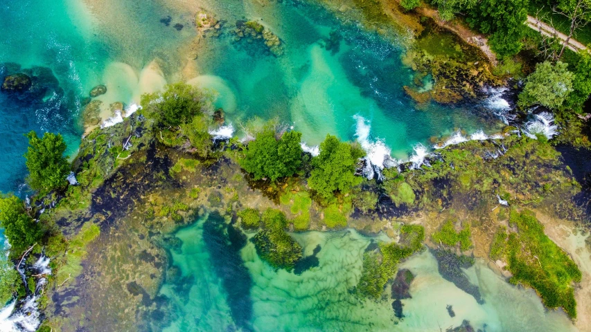 the ocean is covered with colorful green water