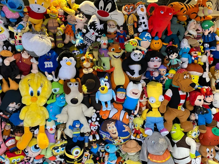 a ortment of stuffed animals, including an orange stuffed animal