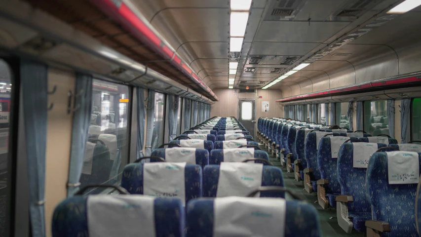 rows of empty blue seats sitting in a train