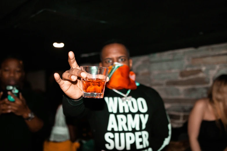 a man holding up a glass with a substance covering it