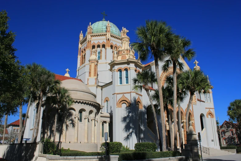 a building with many windows and palm trees