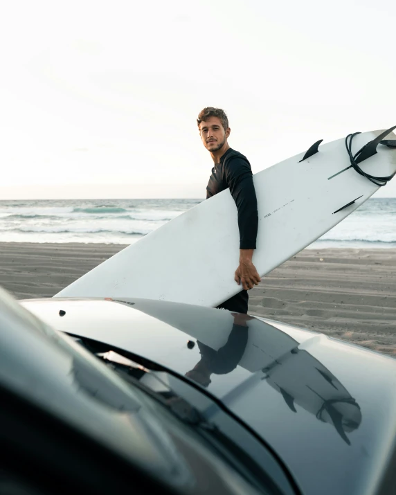 a man with a surfboard is on the beach