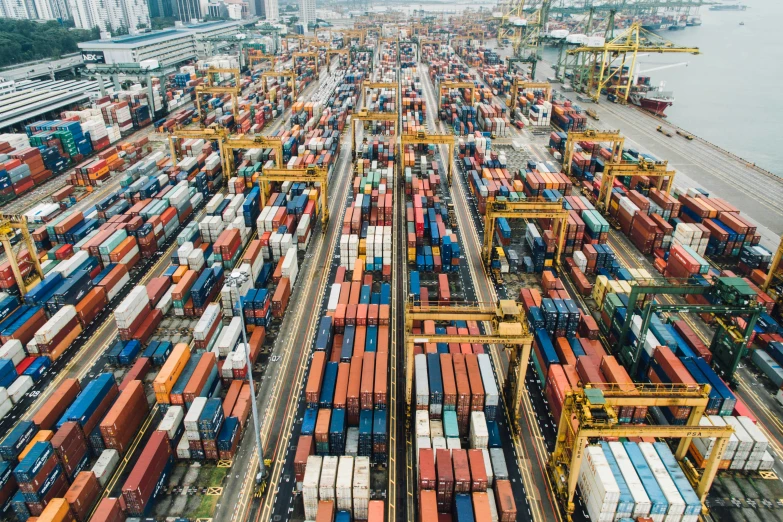 aerial view of many containers at docks in the ocean