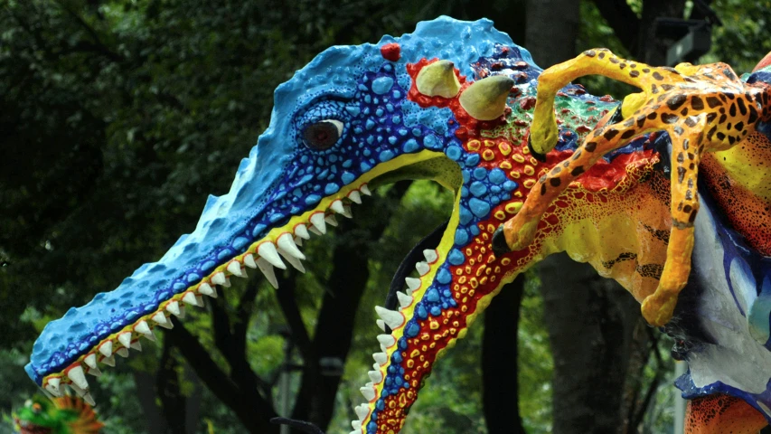 an elaborately painted dragon sculpture in front of trees