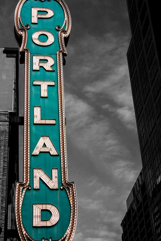 a sign with the word portland next to two buildings