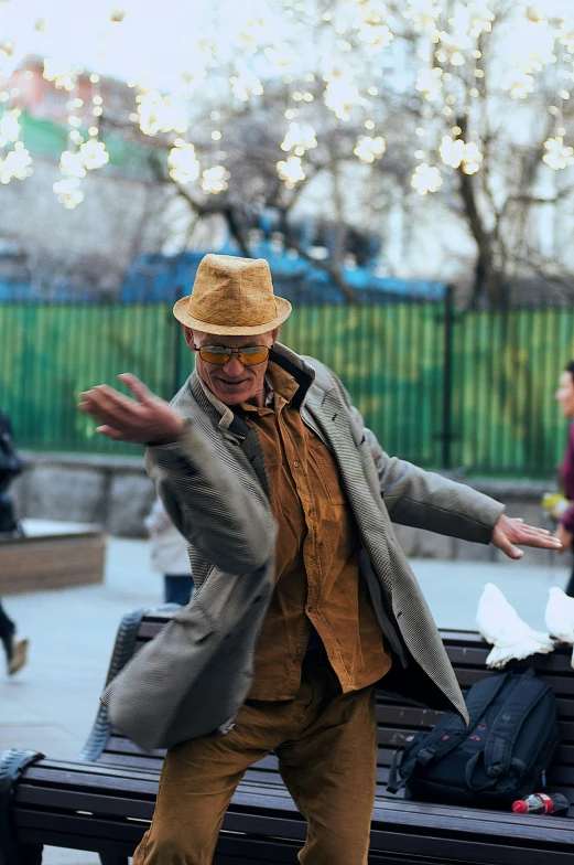 a man leaning against a park bench in the middle of a city