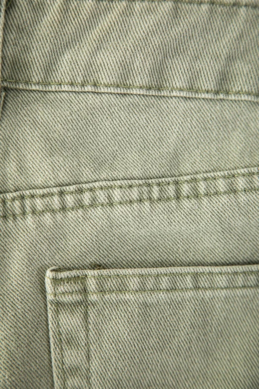 a pair of green denims with a zip closure