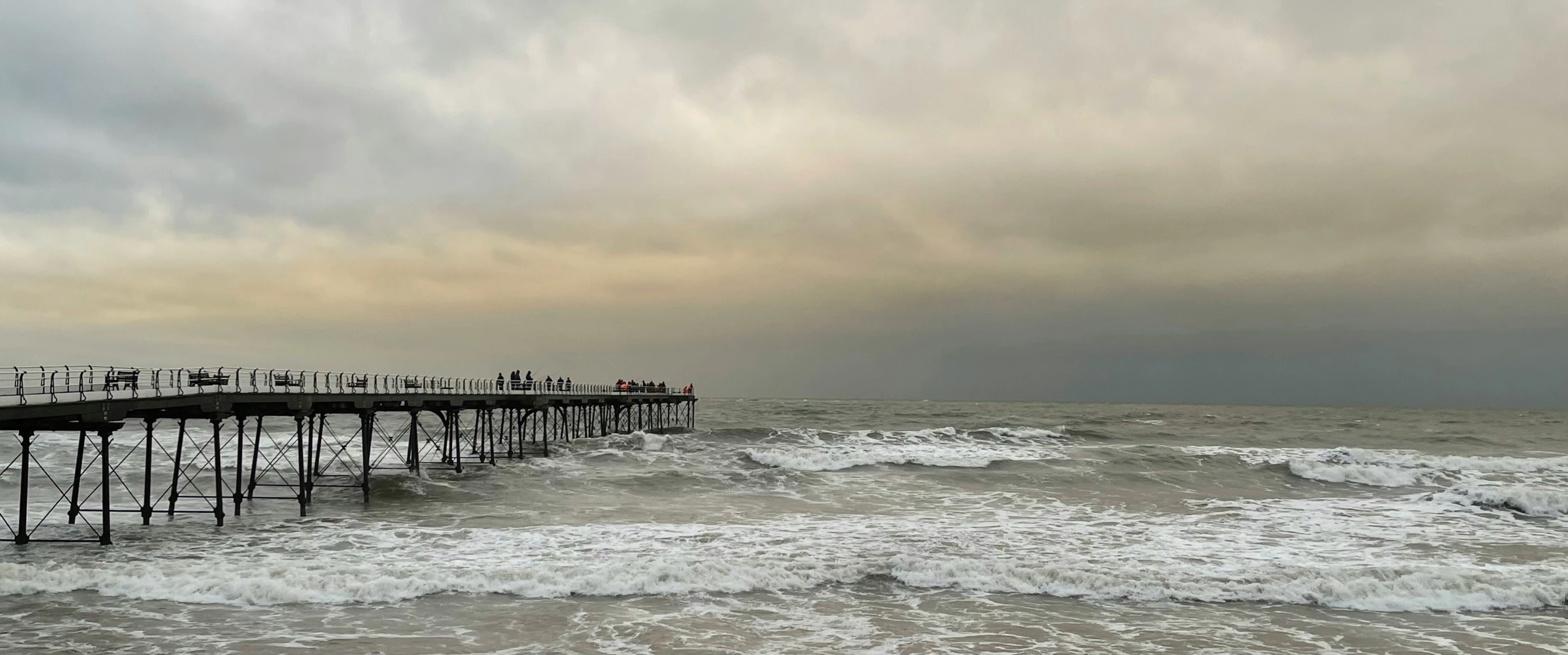 a pier that is in the middle of some water