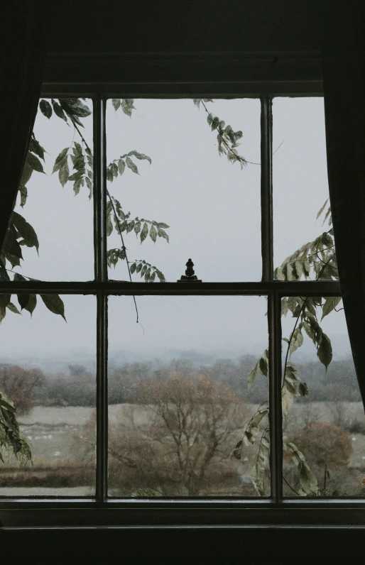 window view of landscape from room with black curtains