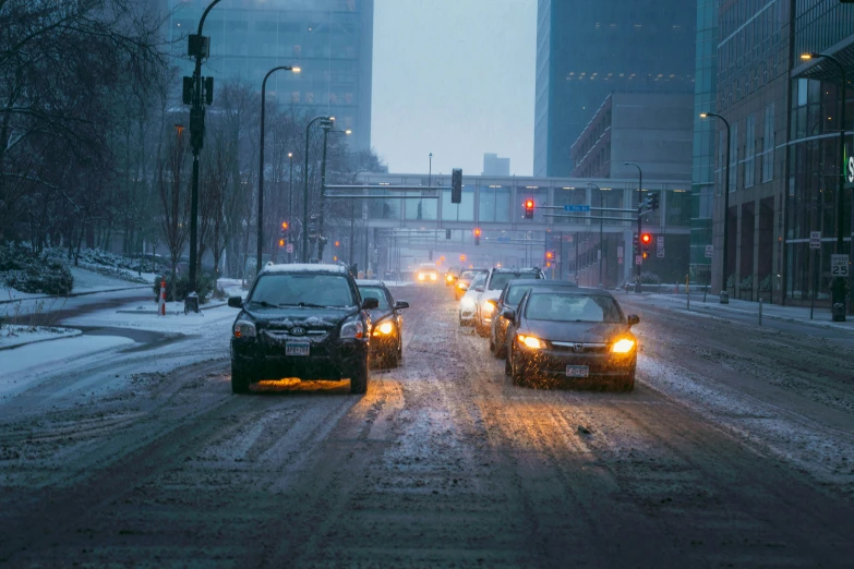 two vehicles are on the road during a snow storm