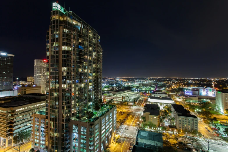 a tall skyscr towering over a city at night