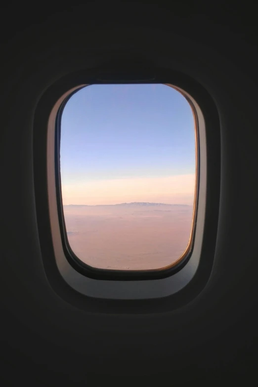 an airplane window view from the inside of it