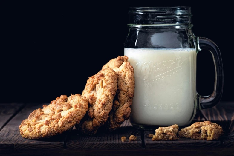 some cookies and a glass of milk are on a table