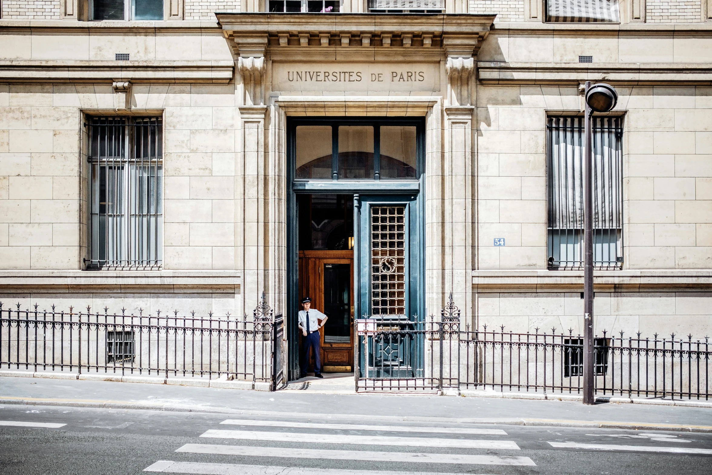 the entrance to a museum and a man standing at the entrance