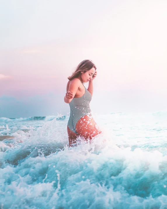 a woman in a bikini walks into the ocean