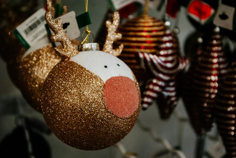 several christmas decorations hanging from strings in the shape of reindeer heads