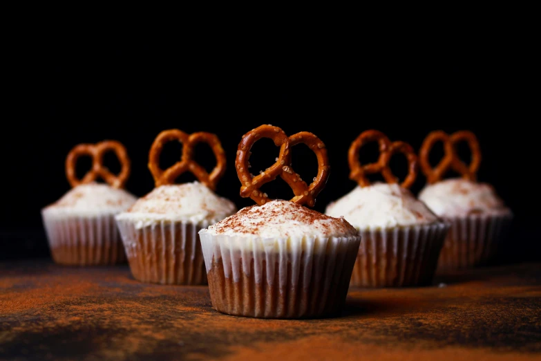 cupcakes covered in icing and pretzel symbols