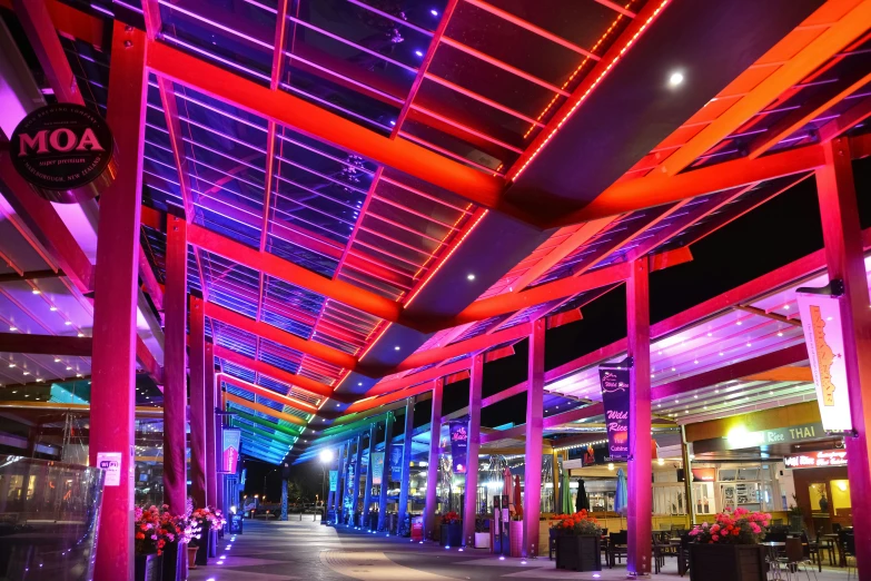 the colorfully lit entrance of a shopping mall