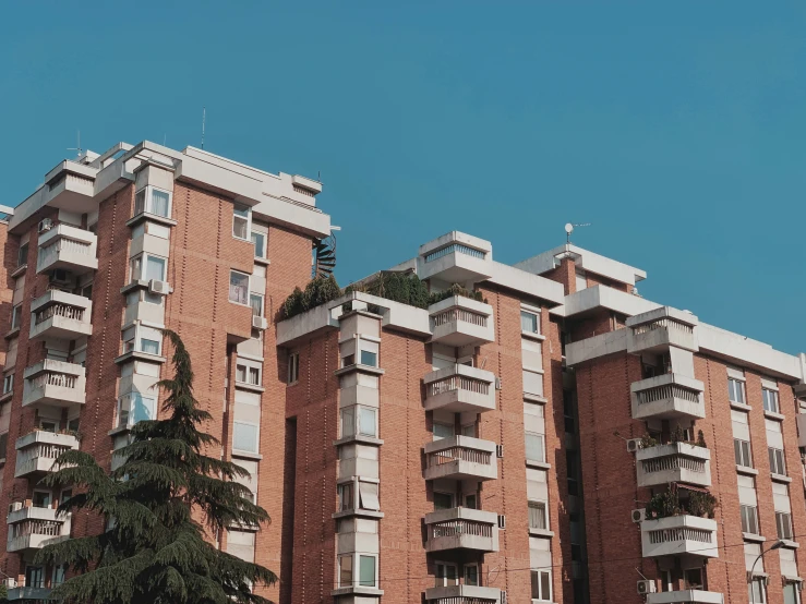 this building has balconies and window panes on the roof