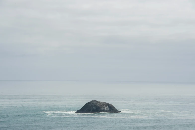 a rocky outcropping in the middle of the ocean