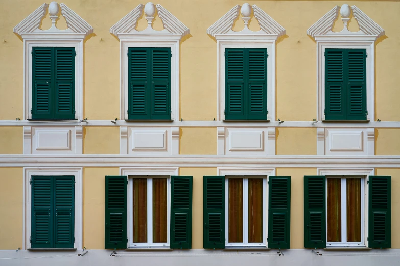 an image of many windows and closed shutters