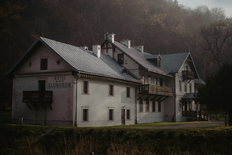 a white house with lots of windows and trees