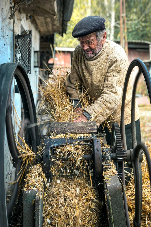 a man loading hay on top of his truck