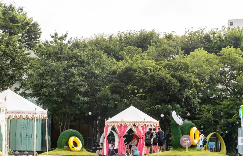 a small tent with balloons and a couple standing in it