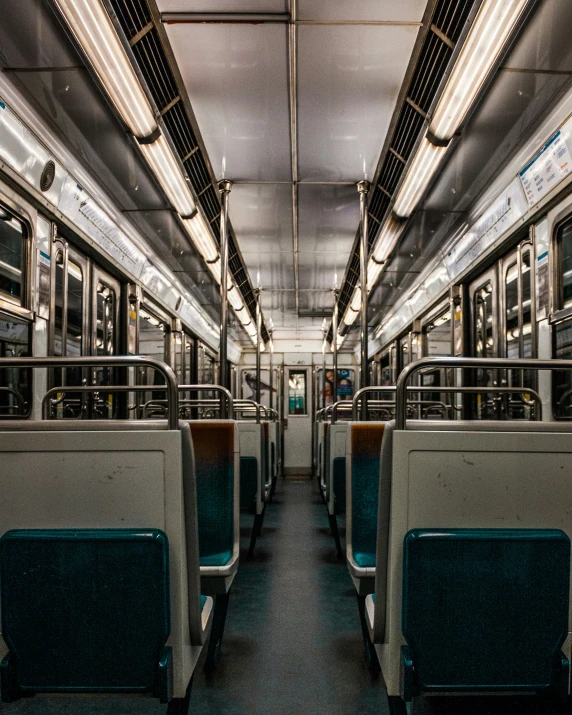 the inside of an empty train carriage with seats