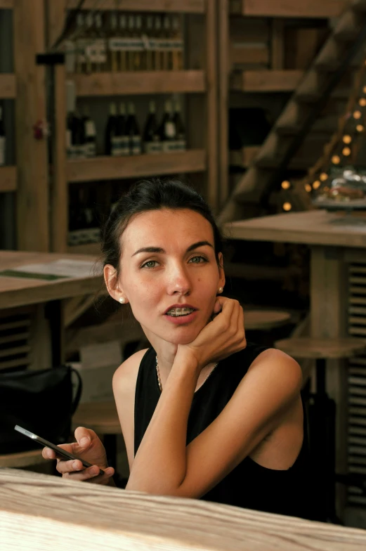 a woman smoking a cigarette in a restaurant