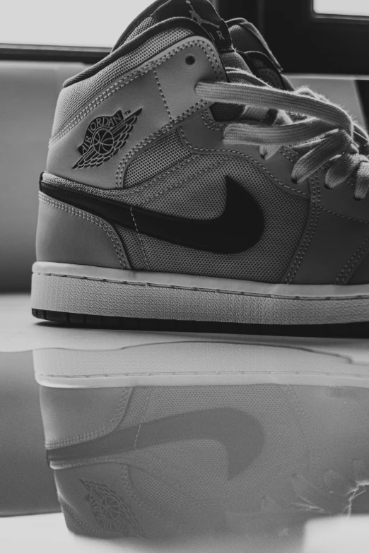 black and white image of a sneaker on a table