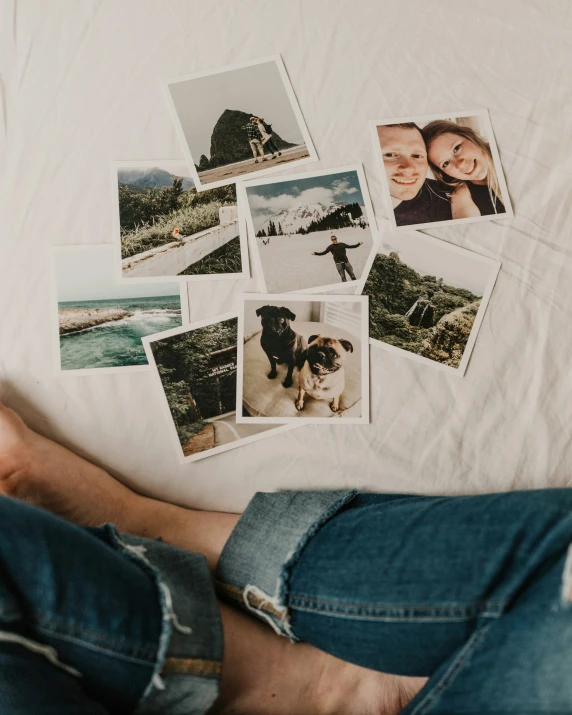 some pictures and people's feet on a white bed