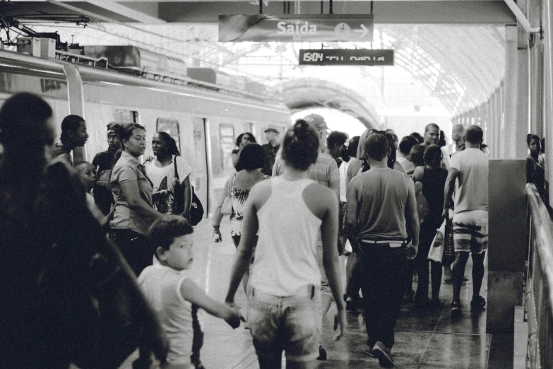 people at the subway train station walking to the next