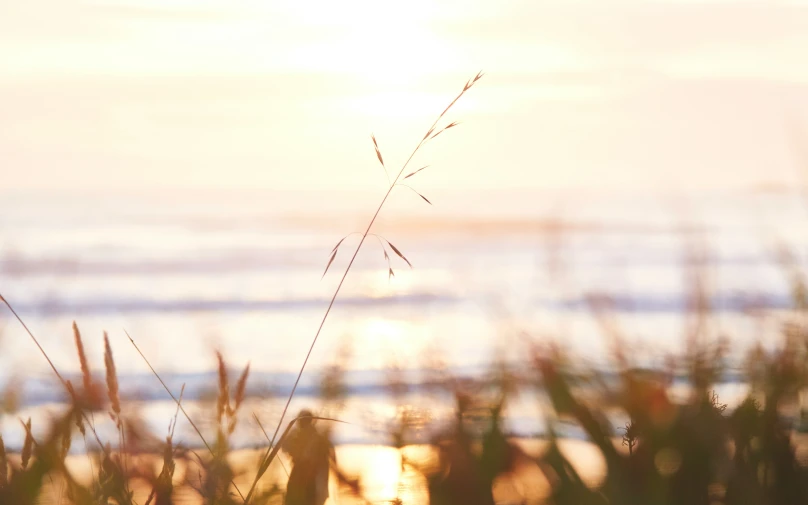 the sun is setting over the ocean with water in the distance