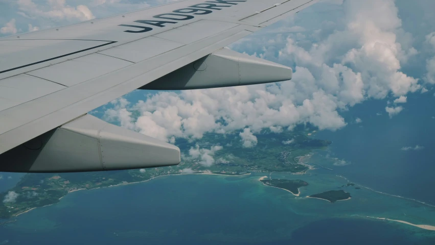 the airplane is flying through the air near a landing strip