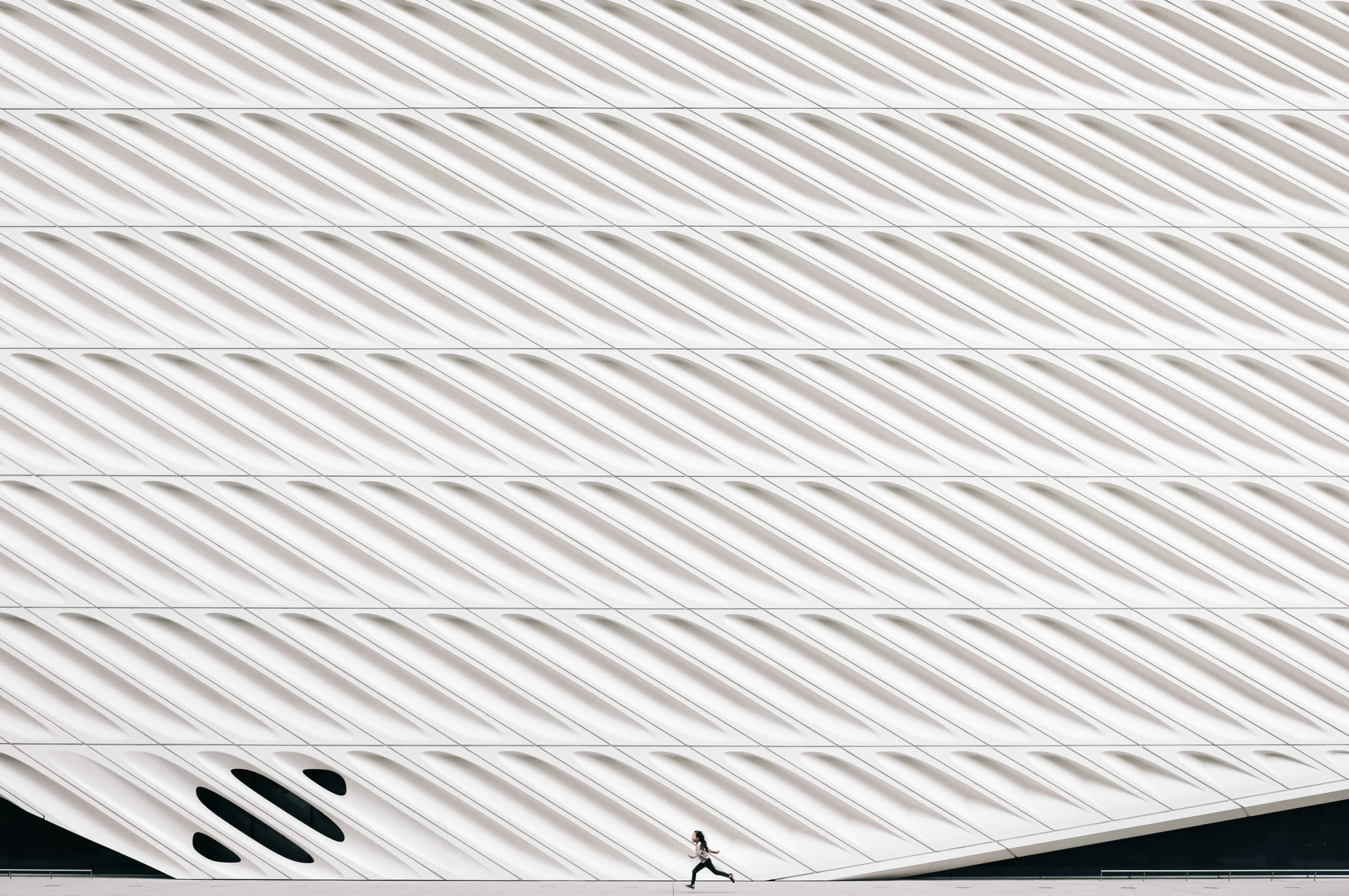 a person walks in front of a building with lines