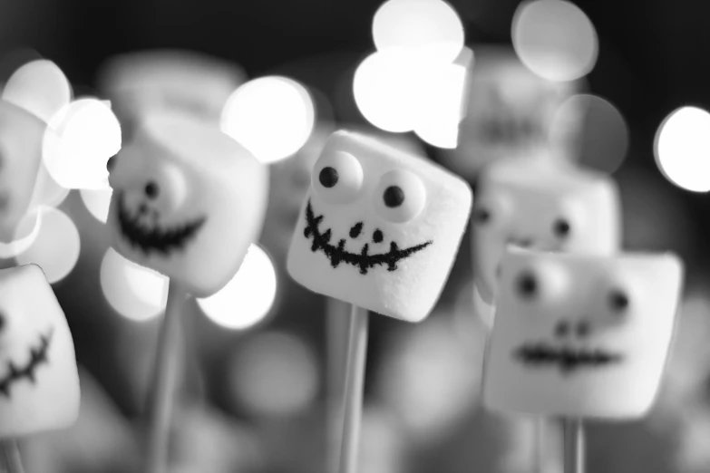 a collection of small lollipops decorated to look like faces