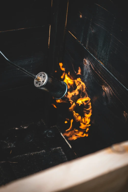 fire burning inside an open oven on top of a stove